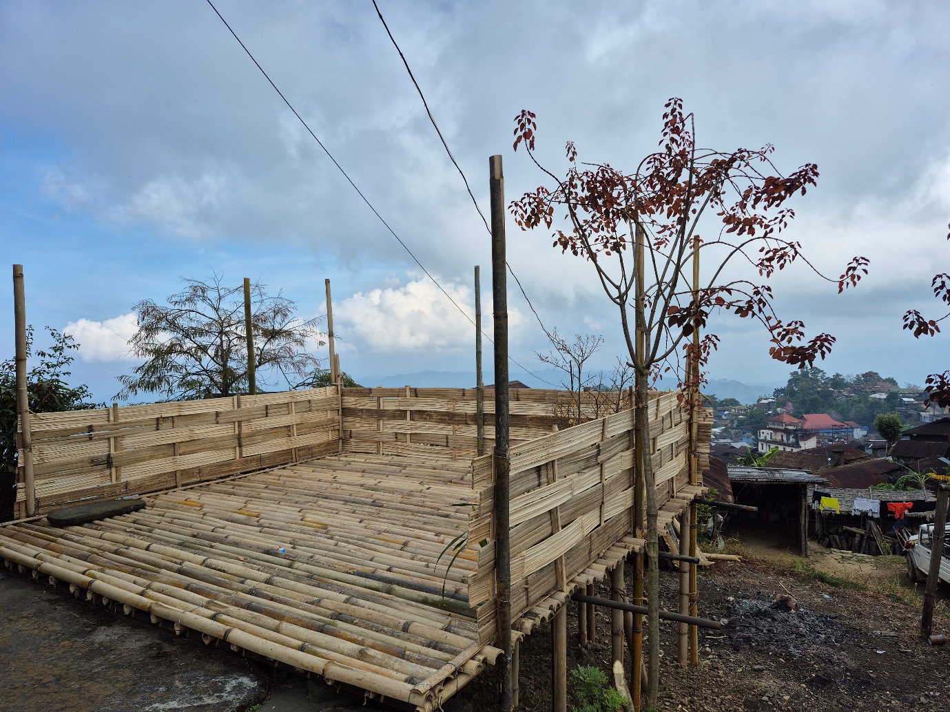 A bamboo structure overlooking village roofs and hills at Longkhum, Nagaland
