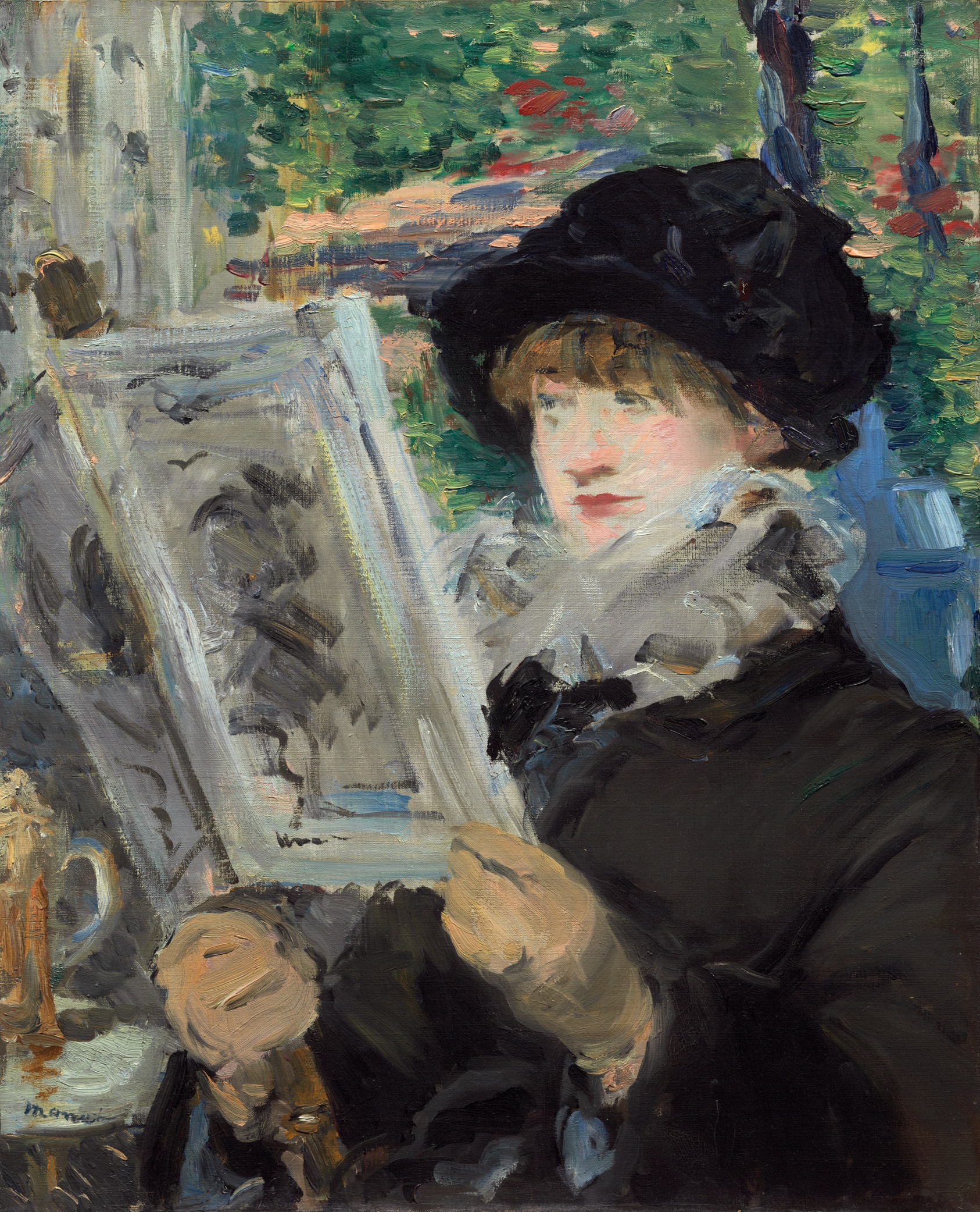A woman in profile reads at a cafe table
