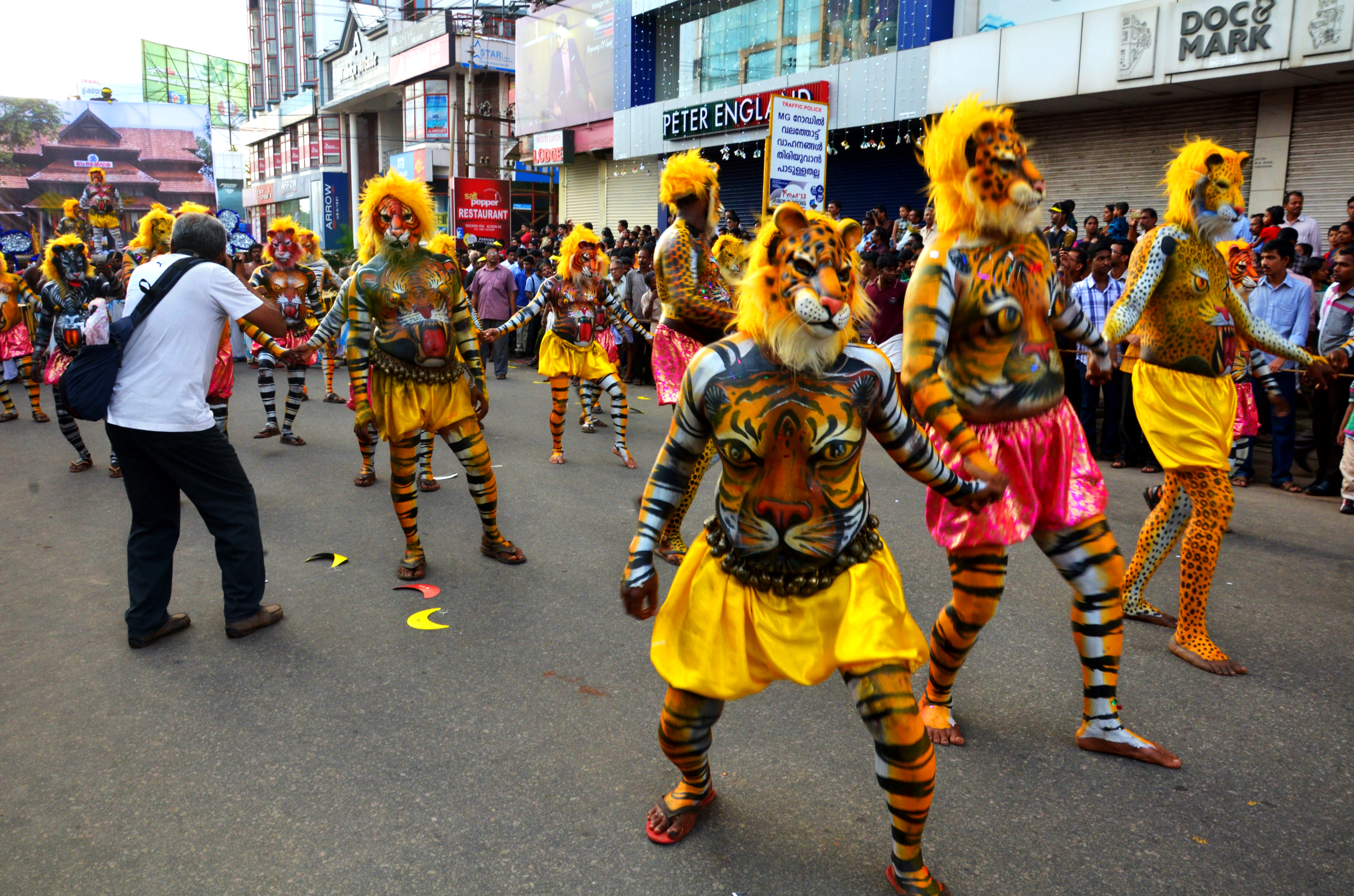 Pulikali performers painted as tigers dance during Onam in Kerala