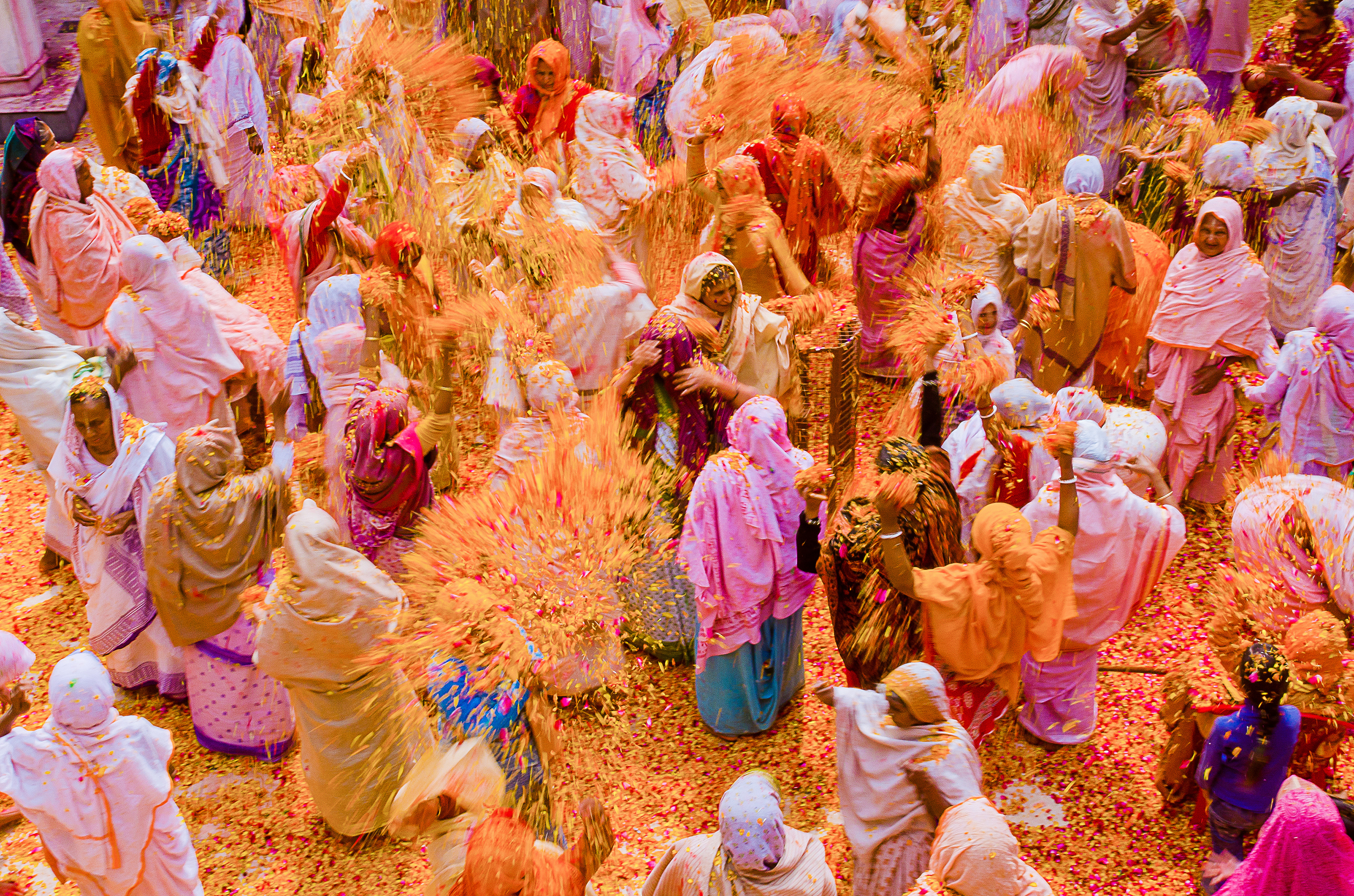 Indian widows celebrate Holi beneath clouds of bright colored powder